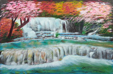 Gentle waterfalls surrounded by beautiful flowering trees of autumn