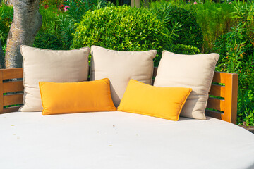 pillows on outdoor patio chair with umbrella
