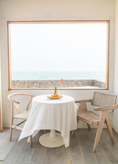 beautiful and empty minimal table and chair on side window