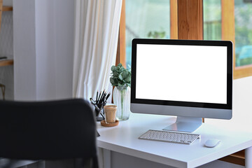 Mock up computer with blank display on white table in modern home office.