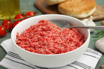Fresh minced meat in bowl on table, closeup