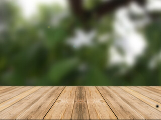 Wood table and forest background for show product or graphics design.