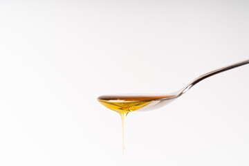 Spoon full of delicious honey with white background