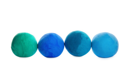 Row of color play dough balls isolated on white