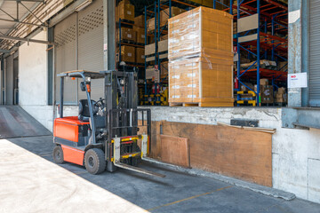 Loading bay at logistics warehouse with forklift