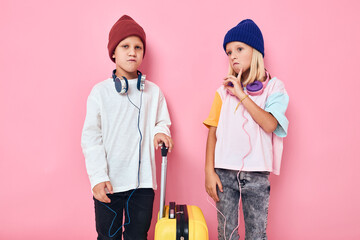 cute smiling kids yellow suitcase with headphones Childhood lifestyle concept