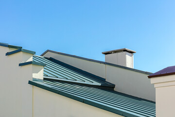 new gray corrugated metal roof against blue sky background