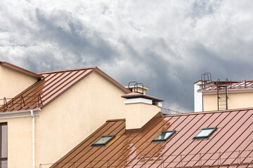 Fototapeta na wymiar wet red metal roof with skylights during rain