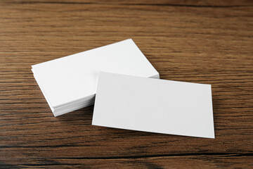 Blank business cards on wooden background. Mockup for design