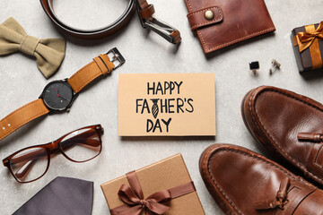 Card with phrase Happy Father's Day, shoes, gift boxes and men accessories on light grey...