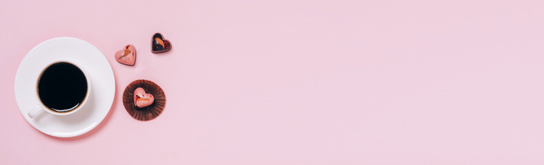 Chocolate candies hearts coffee cup pink background. Flat layout copy space. Holiday concept February 14 Valentine's Day