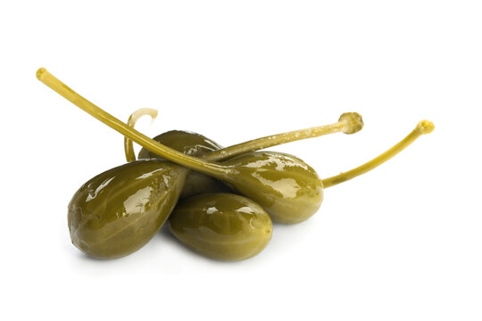 Many delicious pickled capers on white background