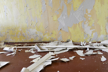 Ragged wallpaper on the wall. Room renovation, wallpaper dismantling. Torn pieces of paper wallpaper.