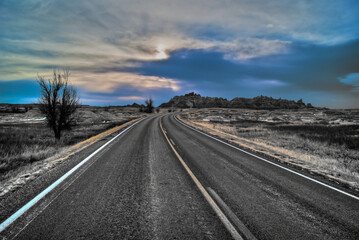 Highway heading towards hills in Badlands National Park