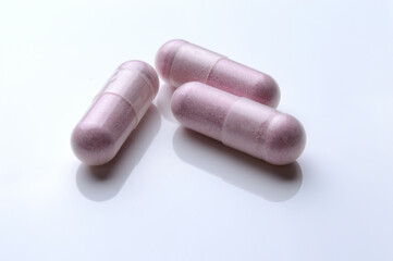 close up of medical capsules on white background