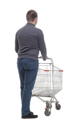 in full growth. casual young man with shopping cart.