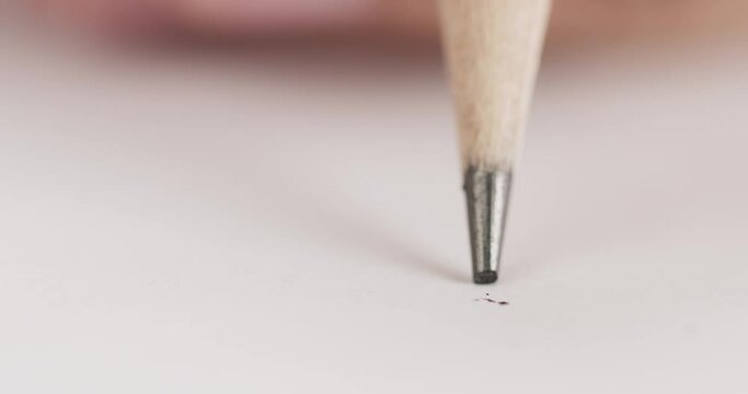 Pencil lead broke while writing on paper. Use a pencil to write something on the paper.