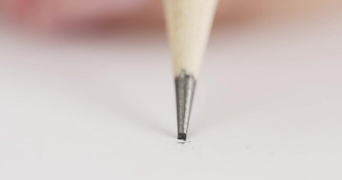 Close up, Pencil broke while writing on paper. Blank white paper.