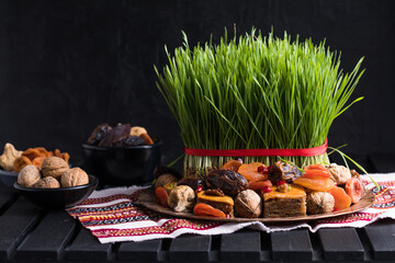 Novruz setting table decoration,  wheat grass, Azerbaijan national pastry pakhlava, new year sring...