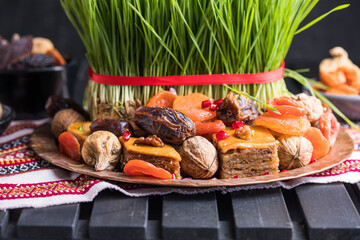 Novruz setting table decoration,  wheat grass, Azerbaijan national pastry pakhlava, new year sring celebration, nature awakening