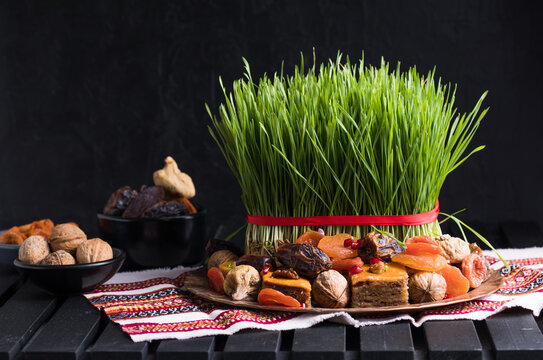 Novruz setting table decoration,  wheat grass, Azerbaijan national pastry pakhlava, new year sring celebration, nature awakening
