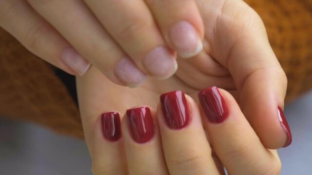 Stylish red female nails. Before and after Modern Beautiful manicure. Autumn winter nail design concept of beauty treatment. Gel nails. Skin care. Wellness. Trendy colors.