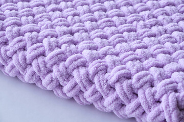 Obraz na płótnie Canvas Warm lilac-colored blanket, home comfort and warmth.