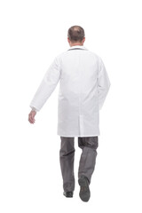 Mature male doctor striding forward. isolated on a white background.