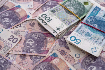 Fototapeta na wymiar Layout of large bills of polish zloty as finance background