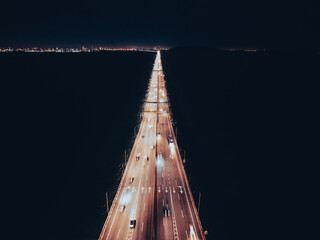 Night top view of the bridge illuminated by road lights