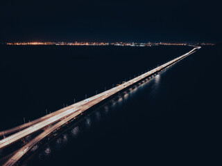 Night top view of the bridge illuminated by road lights