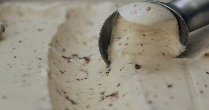 Close up, Scoop marks cookie and  cream with a spoon. The texture of the ice cream and surface.