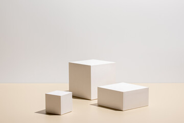 Abstract minimal scene - empty stage with three white rectangle podiums on beige background....