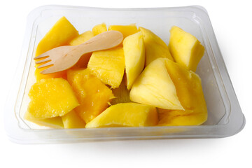 Fresh mango chunks and a small wooden ecology friendly fork in a plastic tray on white isolated background. Food supply industry. Exotic fruit product. Healthy food. Fruit snack for lunch.