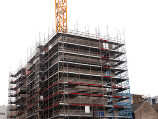 Modern home of office building construction with scaffolding. White background. New house...