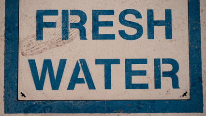 "Fresh Water" Lettering and shoe print on Concrete Floor