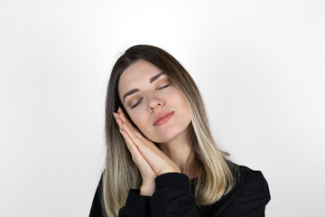 Girl hands cheek sleep gesture. Good night and have nice dreams. Peaceful photo white background...