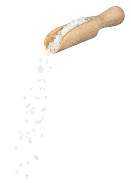 sea salt falling from wooden spoon isolated