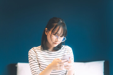 Young adult single woman using smartphone in the moring for online app mental health.