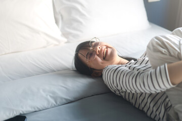 Portrait young adult asian woman relax in bedroom after wake up.