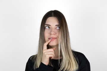 Young beautiful girl wearing casual clothes over isolated white background with hand on mouth thinking about question, pensive expression. Doubt concept. Smiling with thoughtful face. 