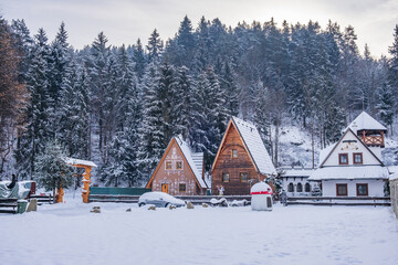 Dolny Kubin, Slovakia - December 26 2021: Traditional log houses, restaurant Koliba and...