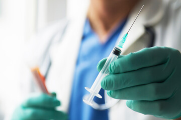 Omicron variant of SARS-CoV-2. New B.1.1.529 Variant of concern. Doctor holds vaccine against new covid-19 omicron variant