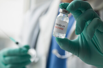 Omicron variant of SARS-CoV-2. New B.1.1.529 Variant of concern. Doctor holds vaccine against new...