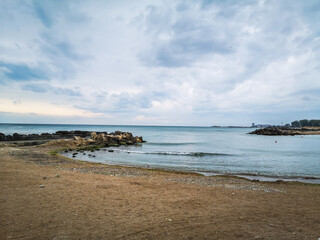 Fototapeta na wymiar Sea shore with blue water, rocks and mistic summer sky