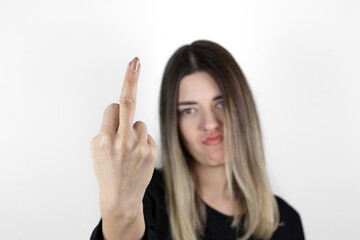 Fuck you hand sign. Bad girl gesture. Provocative and rude gesture doing fuck you symbol with middle finger. The focus is on the fingers.