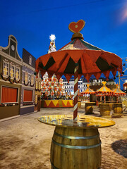 An open cafe at the Christmas Fair on Manezhnaya Square in St. Petersburg, tables from barrels, a fabulous setting, New Year's tree.