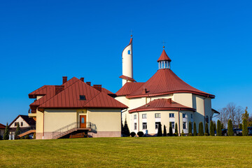 Modernistic Sanctuary of the Divine Mercy church and clergy house in Sedziszow of Podkarpacie region in Lesser Poland - obrazy, fototapety, plakaty