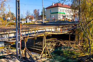 Reconstruction works of the 3 Maja street bridge over Budzisz creek in Sedziszow Malopolski town of Podkarpacie region in Lesser Poland - obrazy, fototapety, plakaty