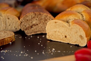 Bread in the shape of a braid. Sweet Challah. Slice of banana bread for breakfast, side view. Cherry tomatoes . High quality photo